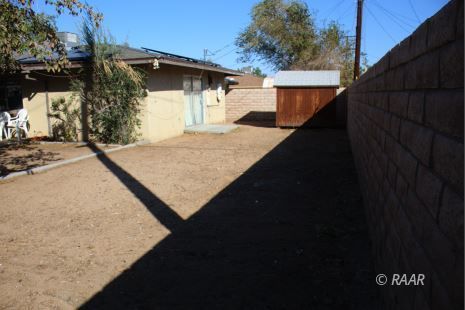 240 South Forest Knoll Street Ridgecrest, CA 93555 - Photo 21 of 23 a view of a house with a wooden fence