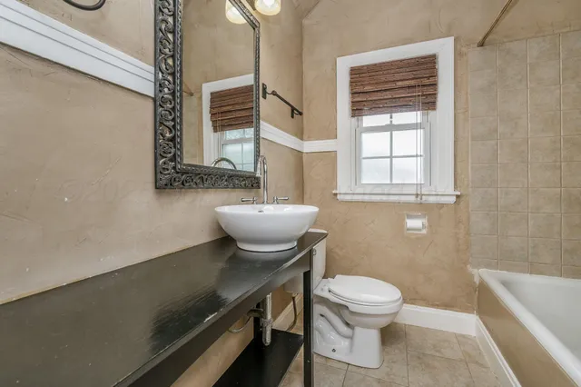 a bathroom with a sink a toilet and tub