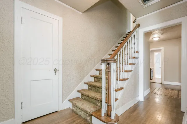 a view of entryway with wooden floor and stairs
