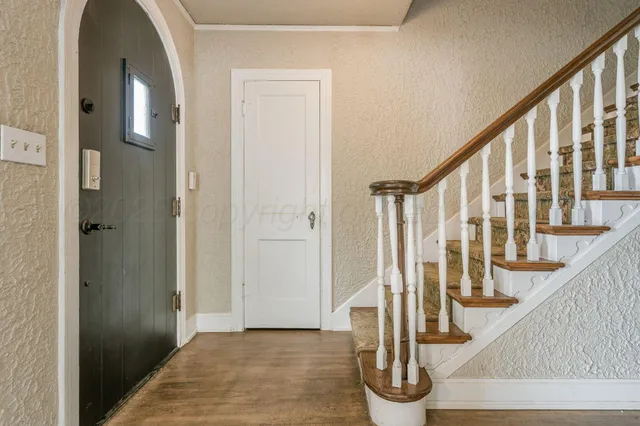 a view of entryway with wooden floor and stairs
