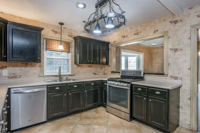 a kitchen with a sink and a stove top oven