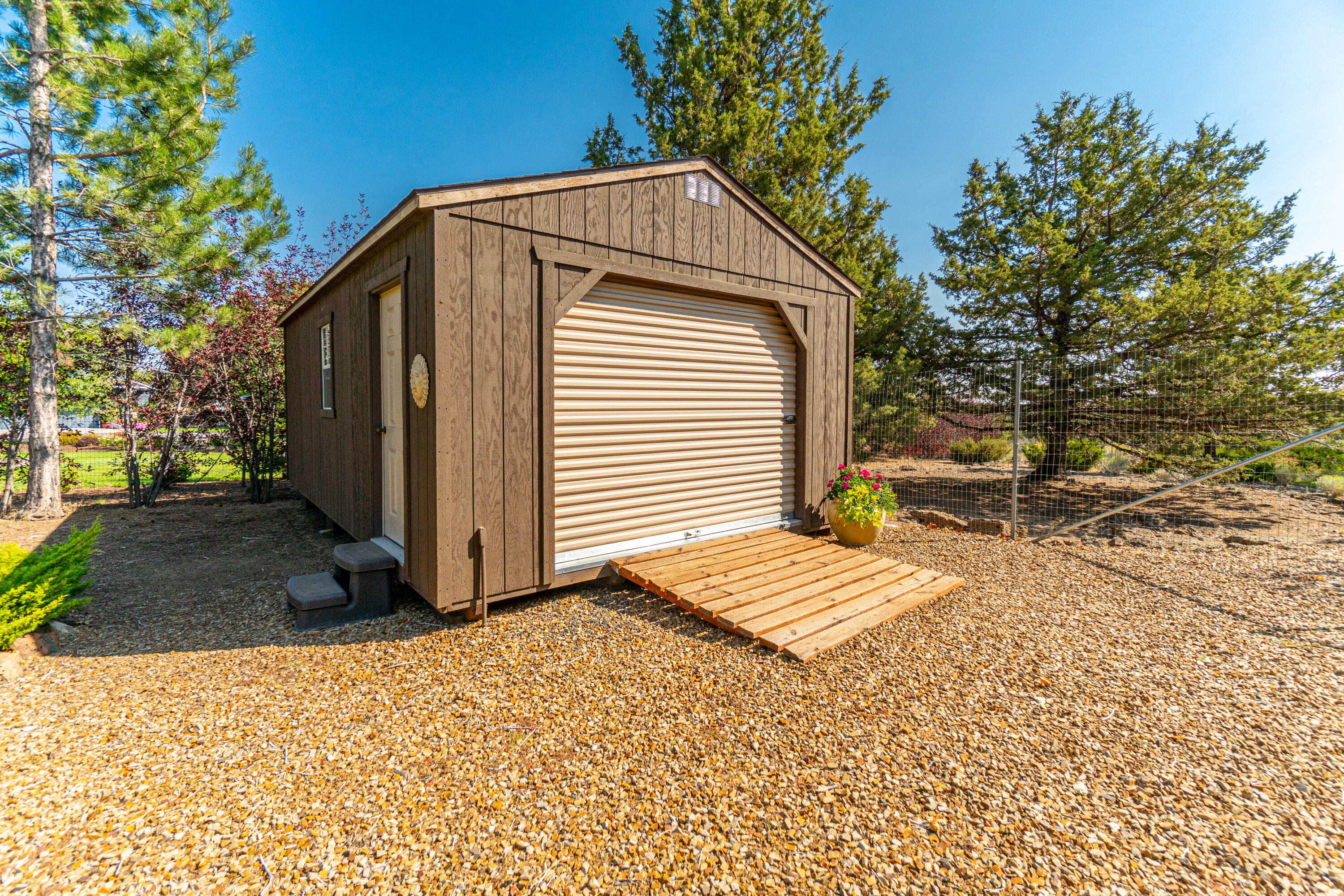 60905 Jennings Road Bend, OR 97702 - Photo 41 of 41 14'x24' Shop has man door and rollup door, built in workbench and extra cabinets as well.
