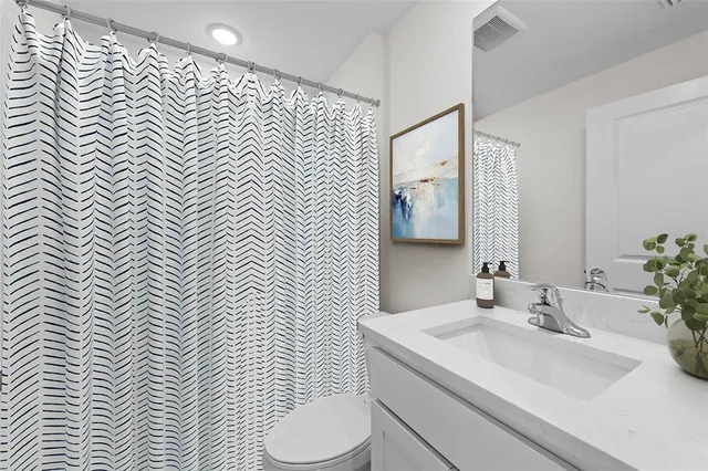 a bathroom with a sink a toilet and mirror