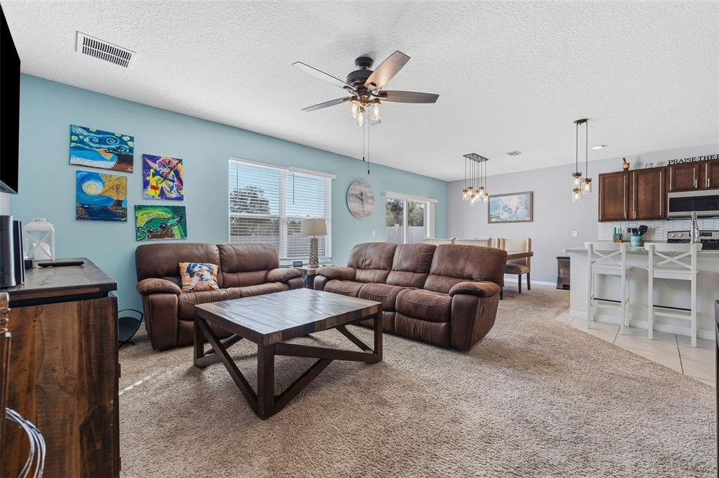1526 White Hawk Way Groveland, FL 34736 - Photo 12 of 40 a living room with furniture and a flat screen tv