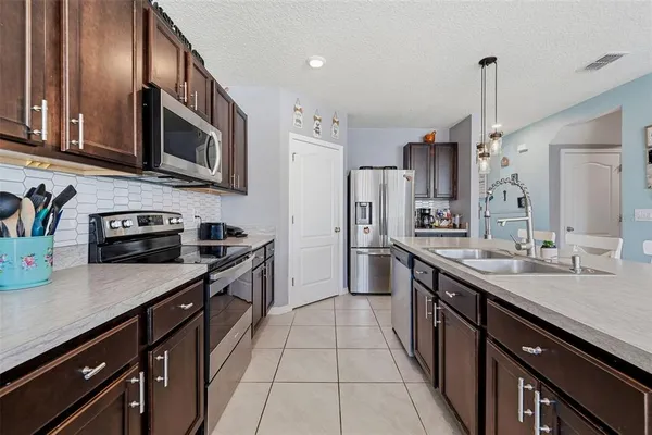 a view of a dining room with furniture a chandelier and wooden floor