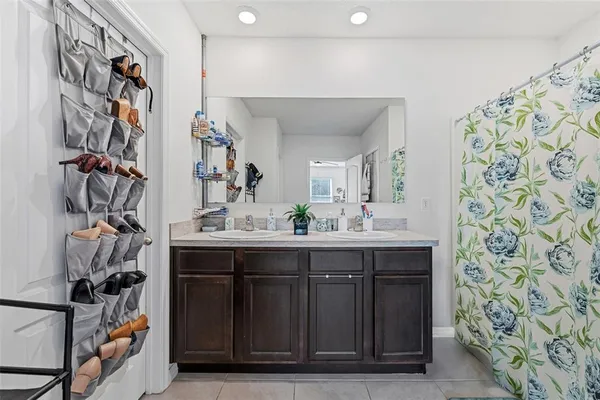 a living room with furniture a flat screen tv and a window
