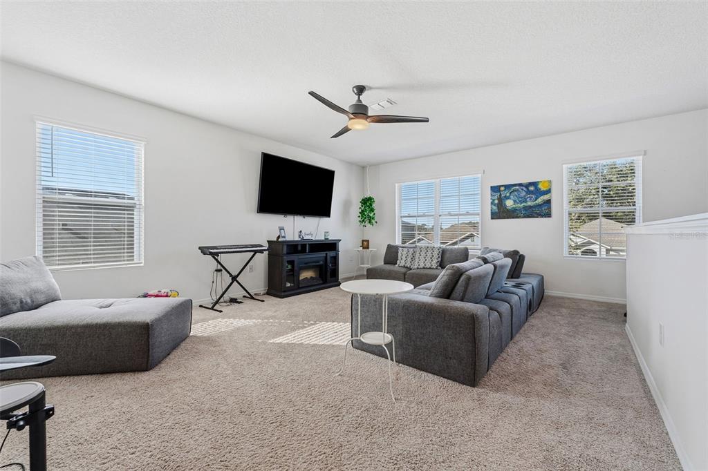 1526 White Hawk Way Groveland, FL 34736 - Photo 23 of 40 a living room with furniture a flat screen tv and a window