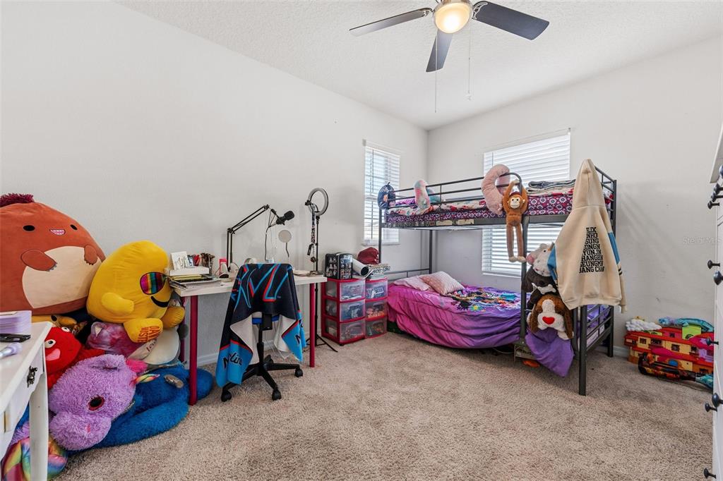 1526 White Hawk Way Groveland, FL 34736 - Photo 28 of 40 a bedroom with baby bed and toys