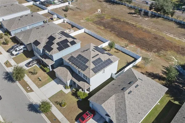 an aerial view of residential house with parking