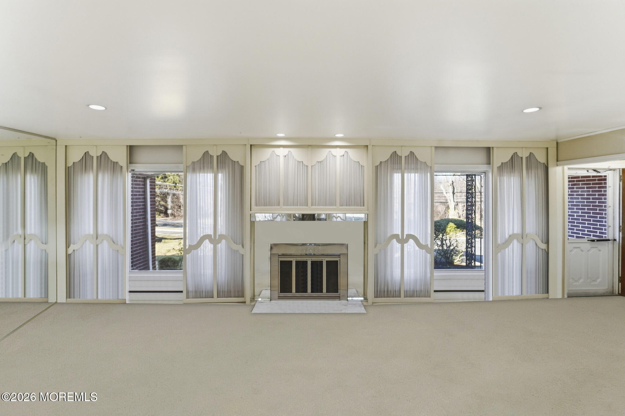 440 Broadway Road Freehold, NJ 07728 - Photo 19 of 50 a view of an empty room with a fireplace and window