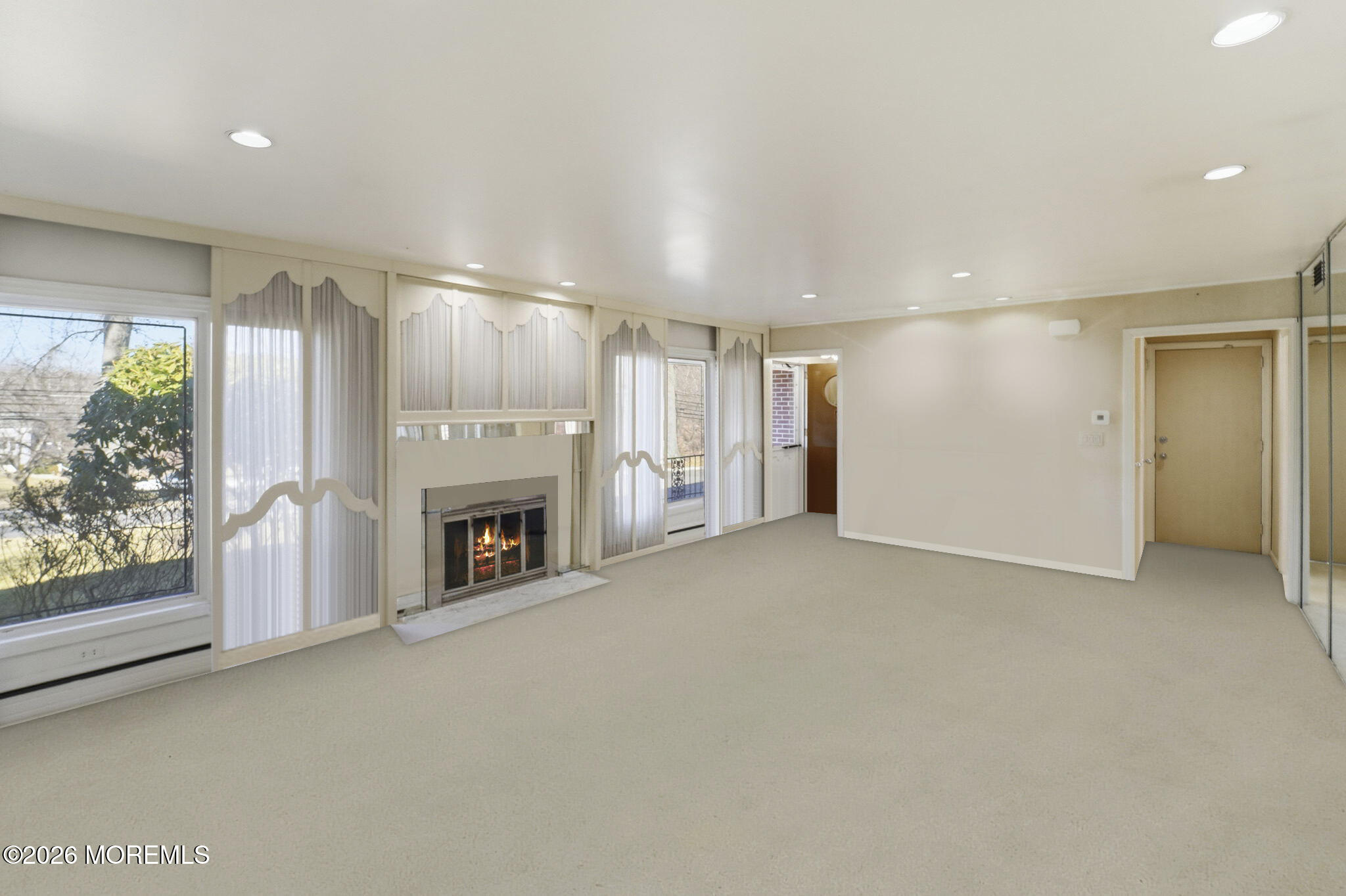 440 Broadway Road Freehold, NJ 07728 - Photo 20 of 50 a view of a livingroom with a fireplace a ceiling fan and window