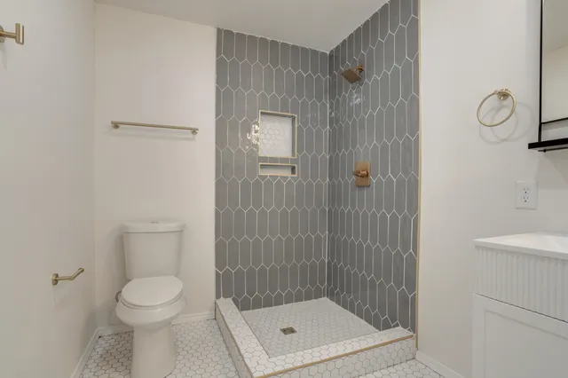 a bathroom with a toilet and a shower