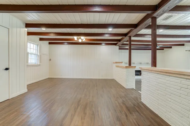a view of a room with wooden floor