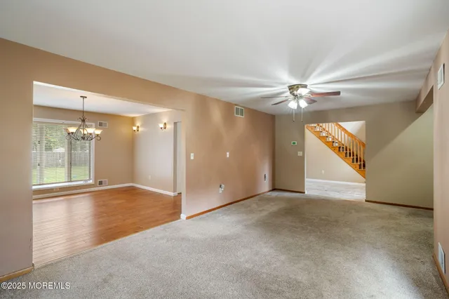 a view of a room with wooden floor and a window
