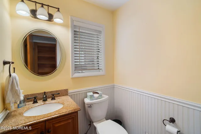 a bathroom with a granite countertop double vanity sink and a mirror