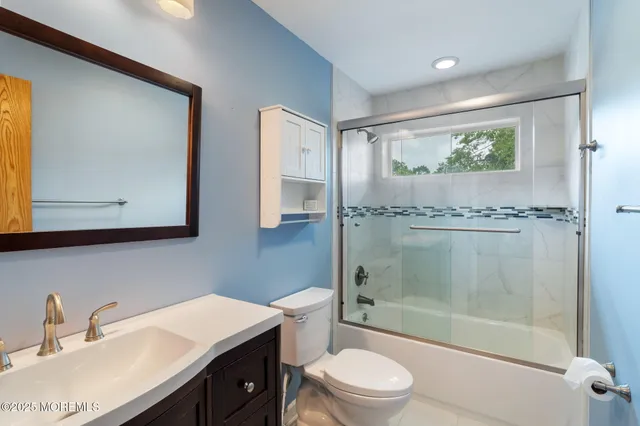 an empty room with a ceiling fan and a window