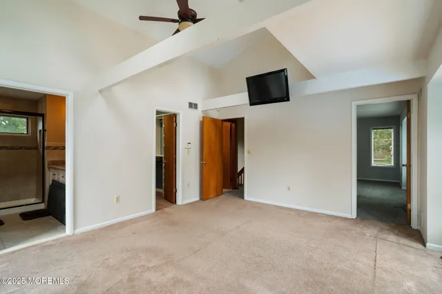 a view of a swimming pool with a patio and lake view