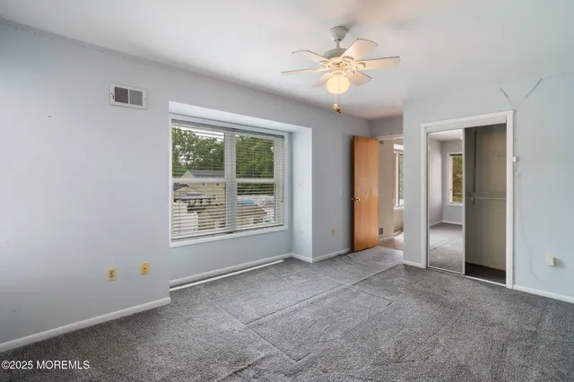 a view of a house with backyard and a tree