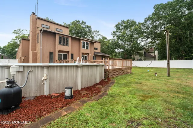 an aerial view of a house with a swimming pool a yard and outdoor seating