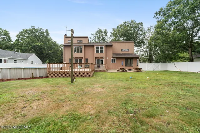 an aerial view of a house with a swimming pool a yard and outdoor seating