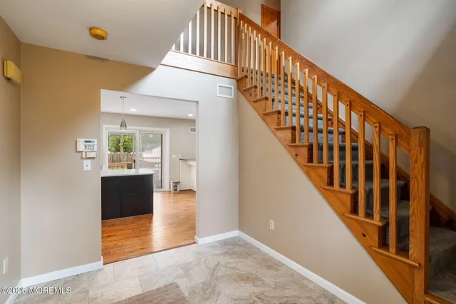 a view of an entryway with wooden floor and door