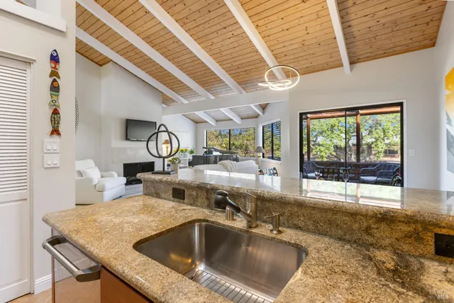 a kitchen with a sink and a wooden floor