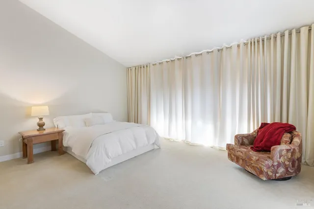 a bedroom with a bed and a curtain