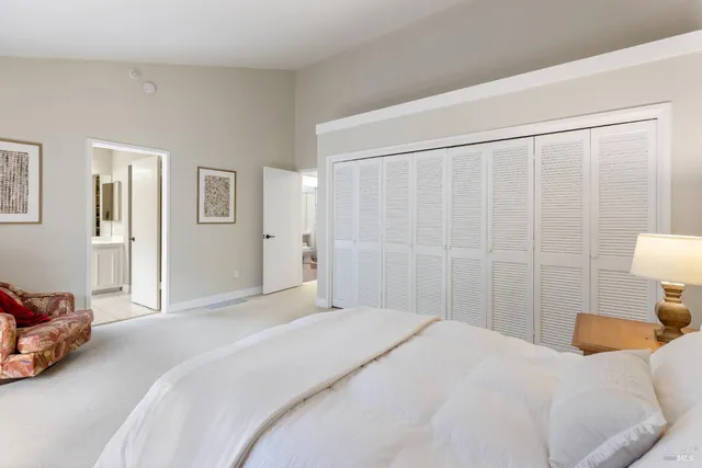 a bedroom with furniture and a large window