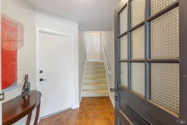 a view of a hallway with wooden floor and windows