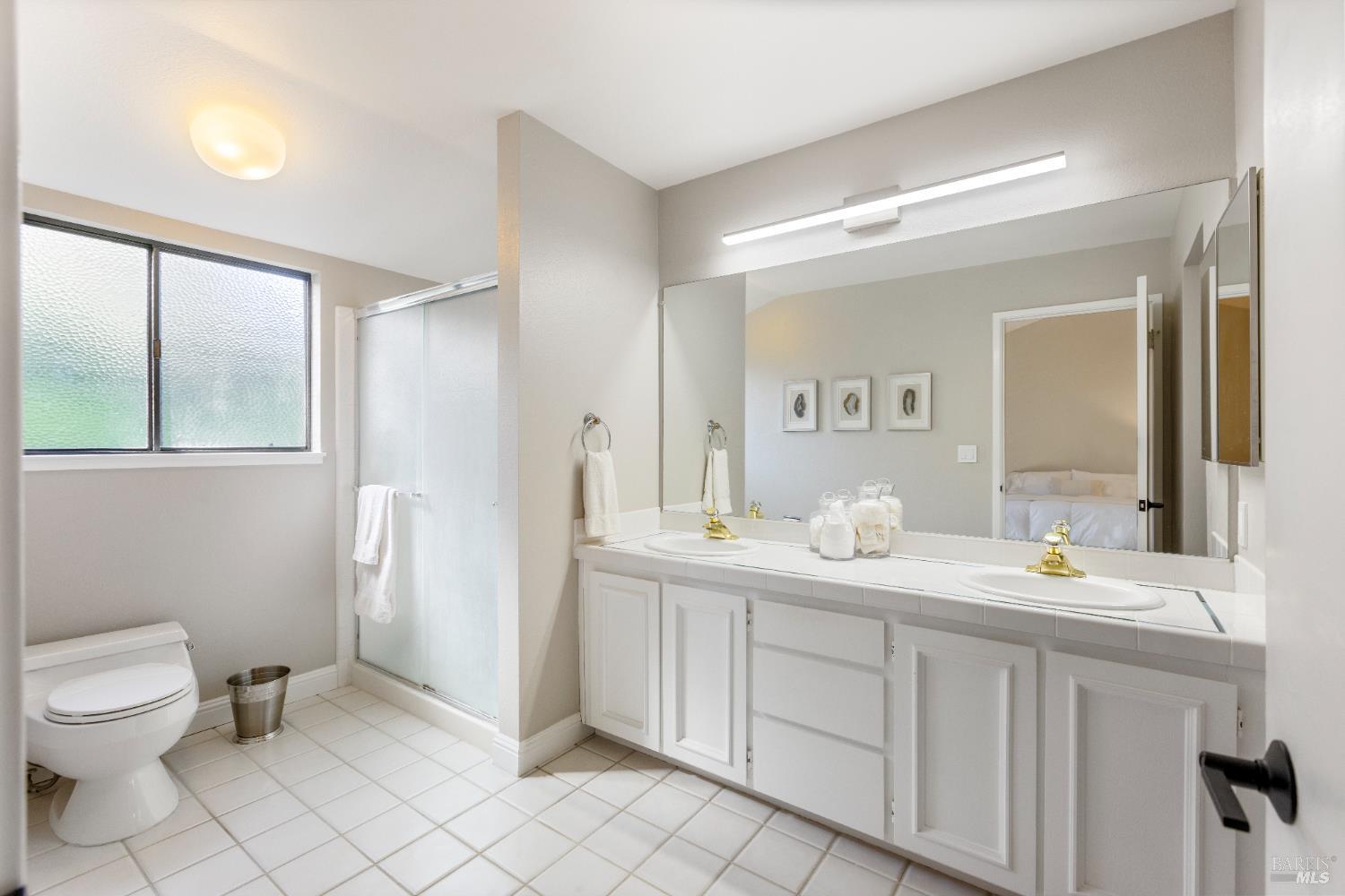 428 El Faisan Drive San Rafael, CA 94903 - Photo 22 of 48 a spacious bathroom with a double vanity sink toilet and mirror