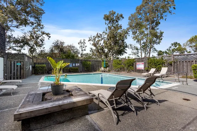 a view of backyard with seating space and trees