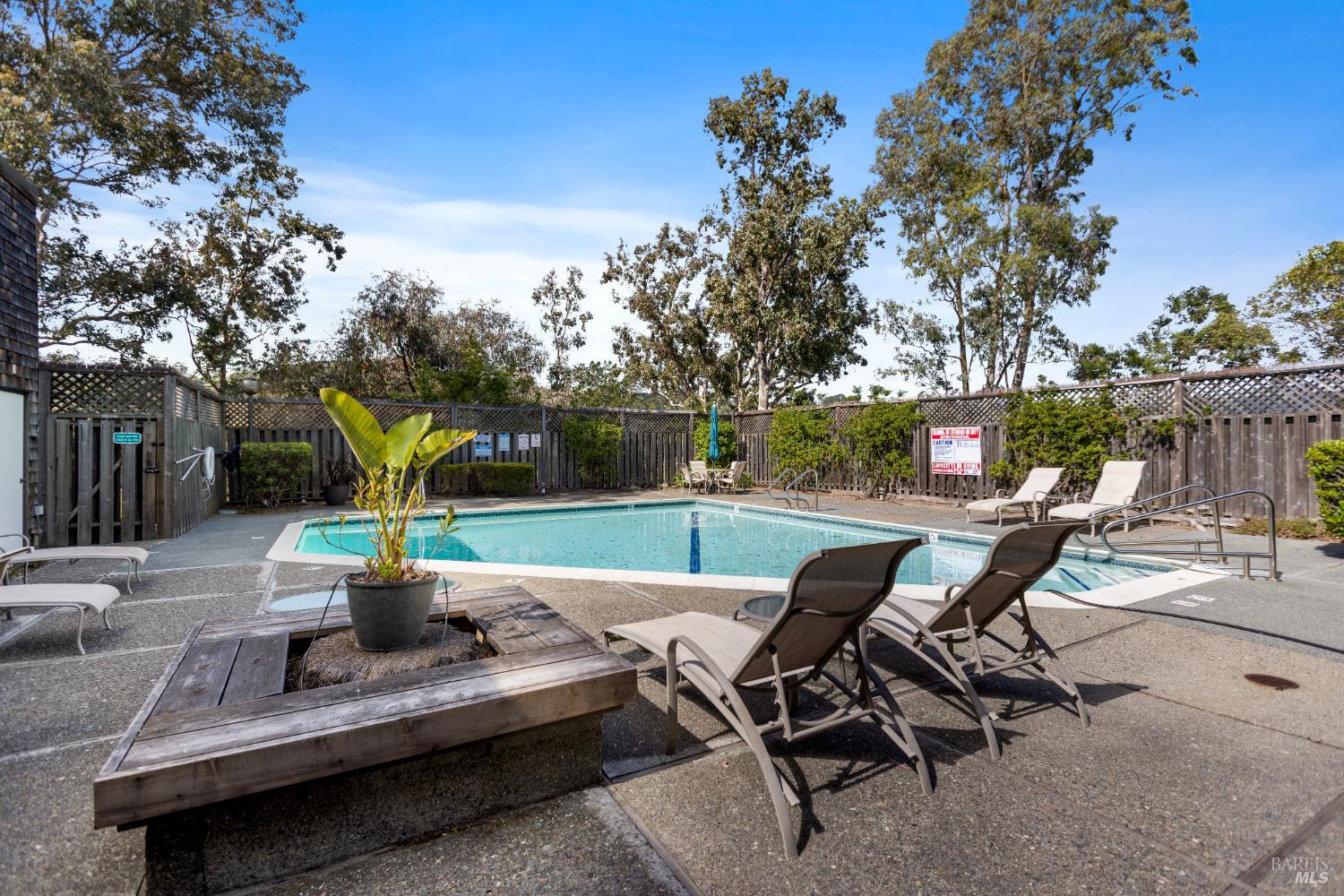 428 El Faisan Drive San Rafael, CA 94903 - Photo 37 of 48 a view of a patio with table and chairs potted plants with wooden fence