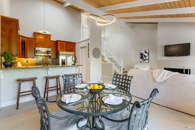 a view of a dining room with furniture and a flat screen tv