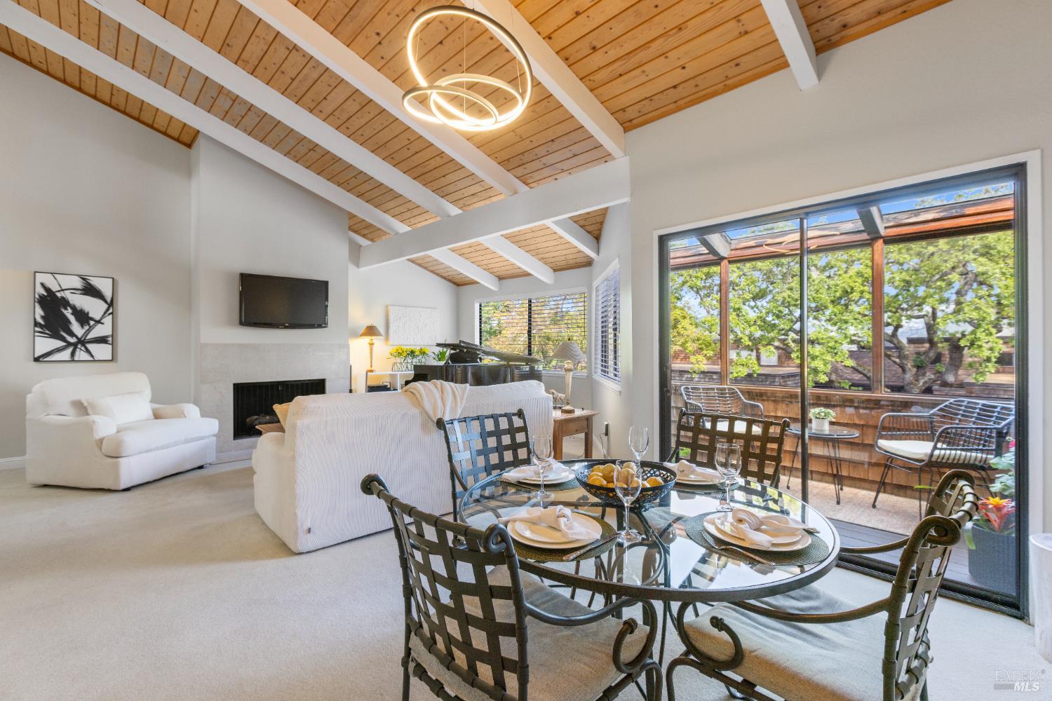 428 El Faisan Drive San Rafael, CA 94903 - Photo 5 of 48 a dining room with furniture a fireplace and large windows