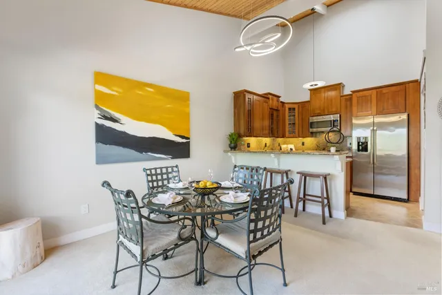 a dining room with furniture and a floor to ceiling window