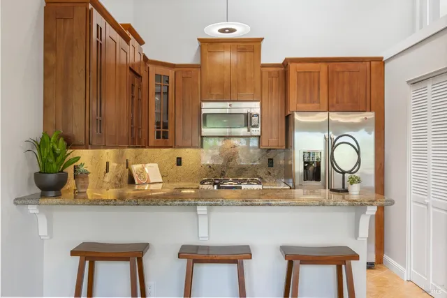 a bathroom with a granite countertop sink a mirror and a window