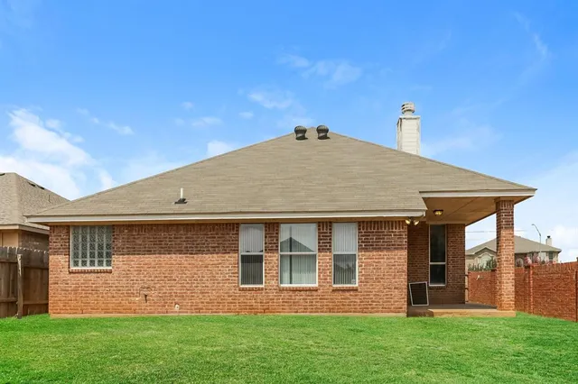 a front door view of a house with a yard