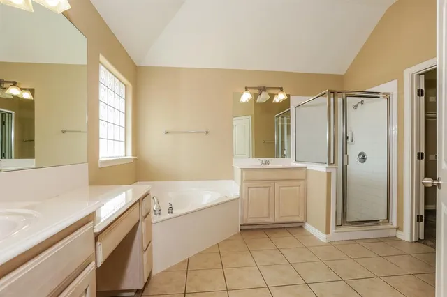 a bathroom with a tub sink and mirror