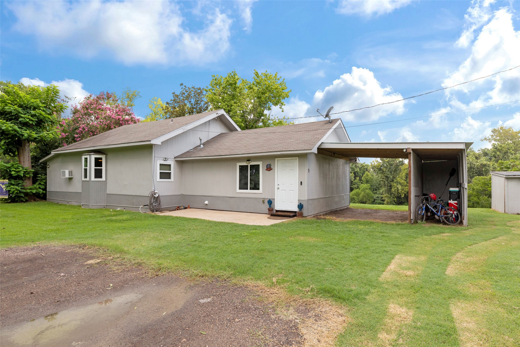 a view of a house with a yard and sitting area