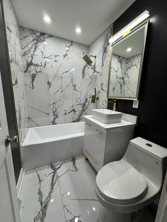 a bathroom with a toilet sink and tub