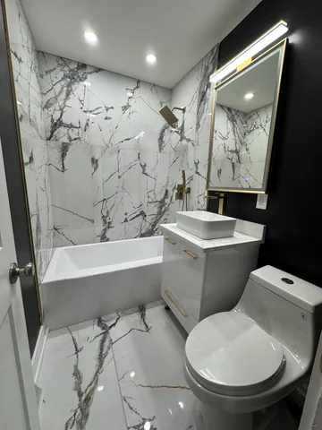 a bathroom with a toilet sink and tub