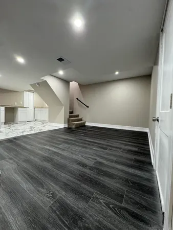 a view of an empty room and wooden floor