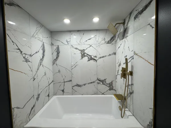 a bathroom with a bathtub and shower