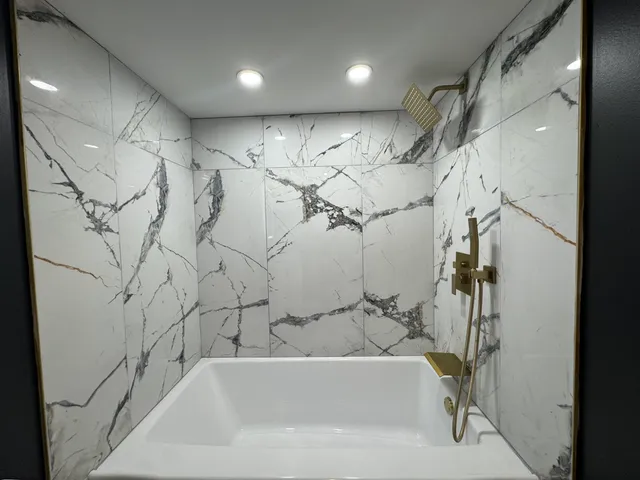 a bathroom with a bathtub and shower