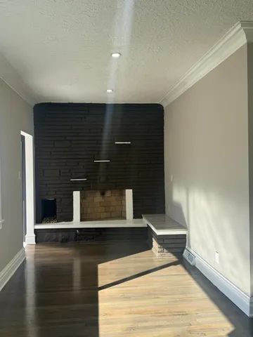 a view of water heater room with wooden floor