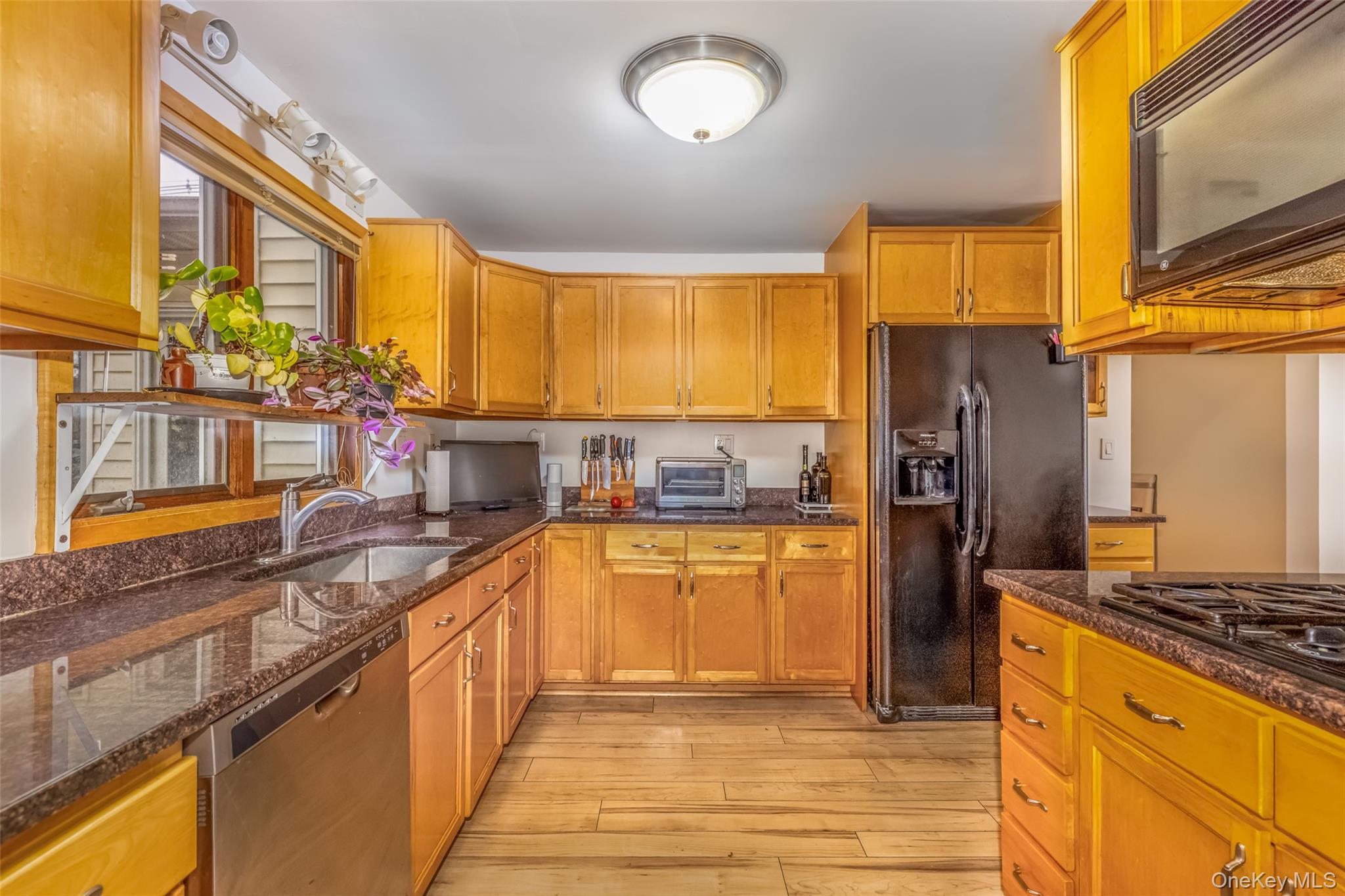1896 Rte 44 55 Modena, NY 12548 - Photo 21 of 48 Kitchen featuring black appliances, brown cabinets, and dark stone counters