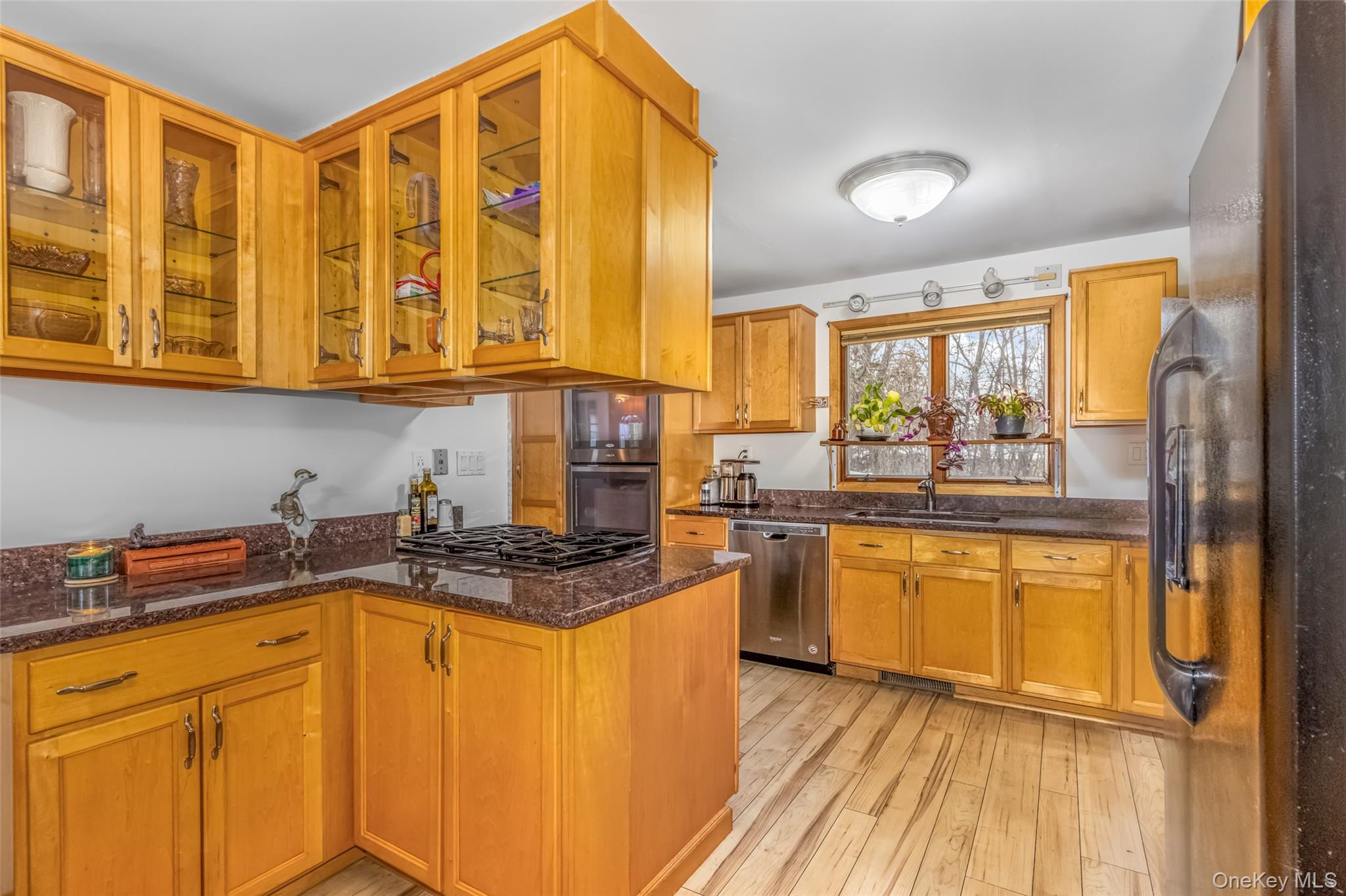 1896 Rte 44 55 Modena, NY 12548 - Photo 22 of 48 Kitchen with stainless steel appliances, dark stone counters, brown cabinets, and glass insert cabinets