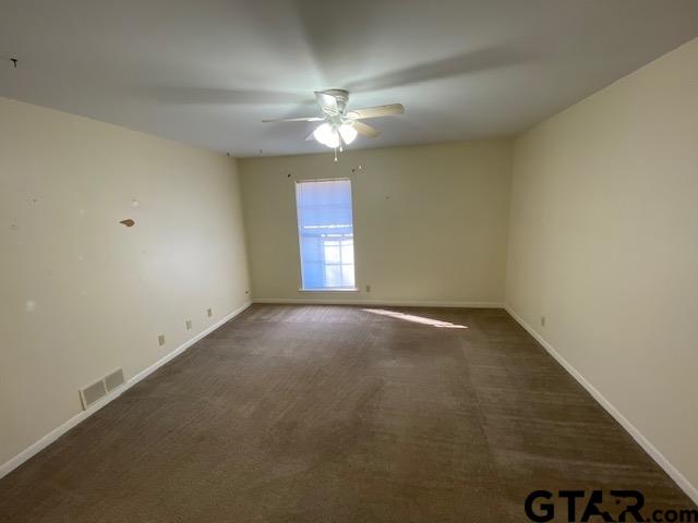 5700 Foxcroft Road Tyler, TX 75703 - Photo 7 of 10 an empty room with a ceiling fan and window