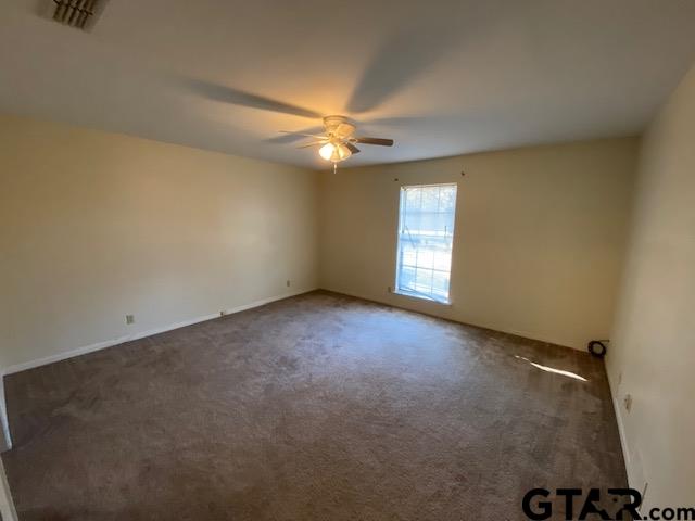 5700 Foxcroft Road Tyler, TX 75703 - Photo 8 of 10 an empty room with windows and fan