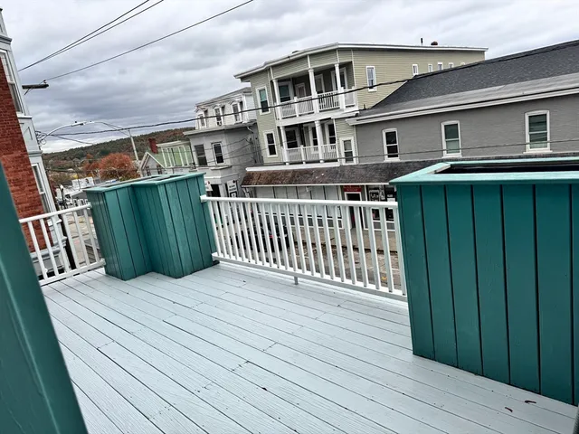 a view of a house with wooden deck front door